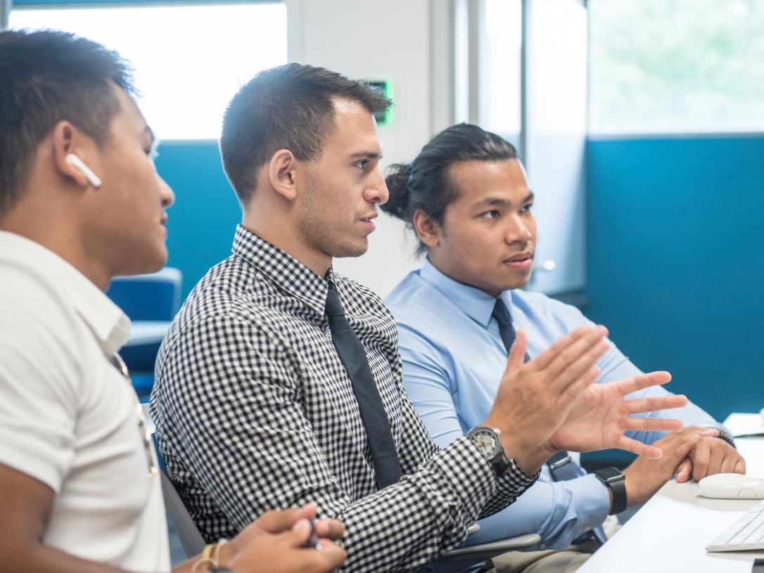 A group of male students working in the library