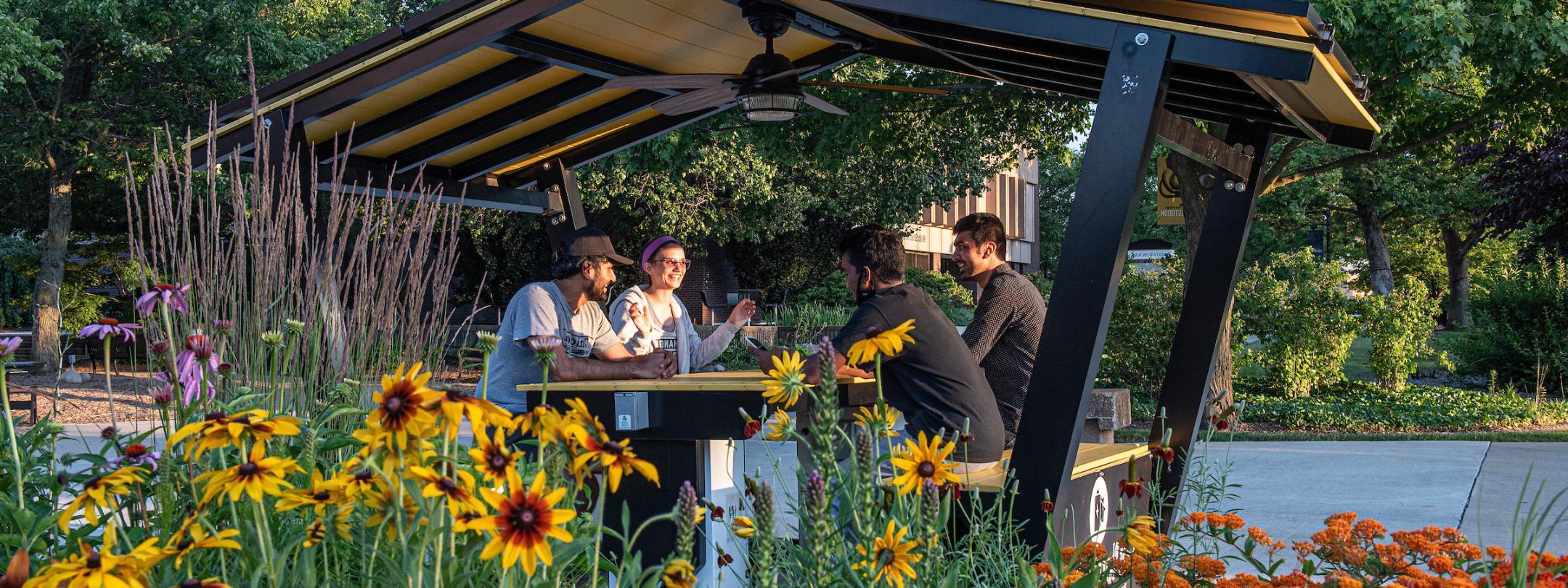 Students sitting in the solar hut